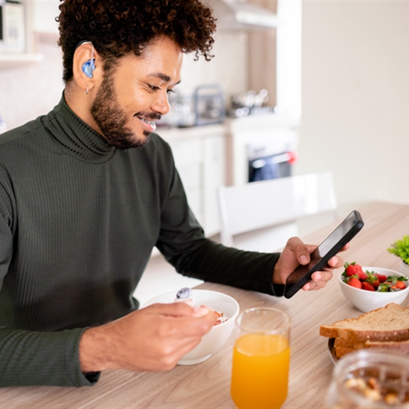 Hearing impaired man using his phone Hearing impaired man using his phone