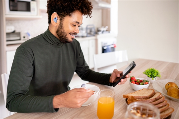 Hearing impaired man using his phone Hearing impaired man using his phone